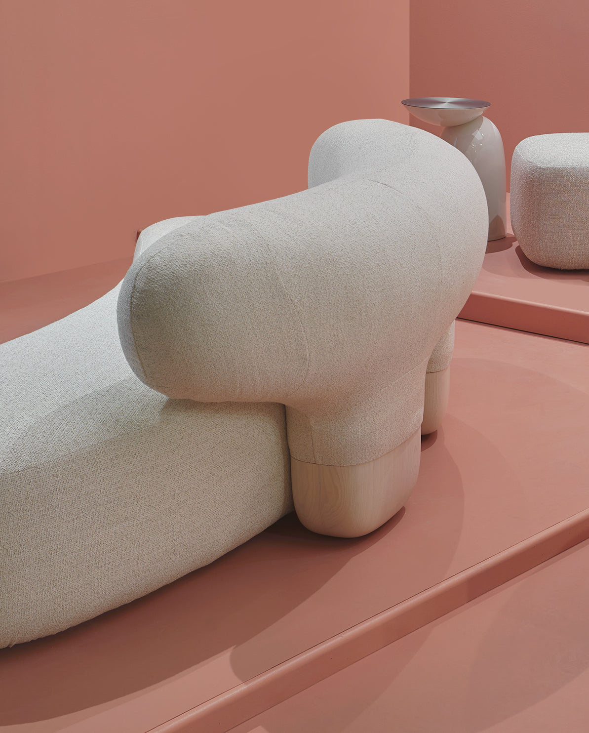 Asawa Sofa on a pink platform, detail of arm and feet