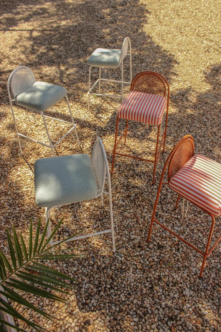 Riviera Bar Chair collection in sage, white and copper on gravel