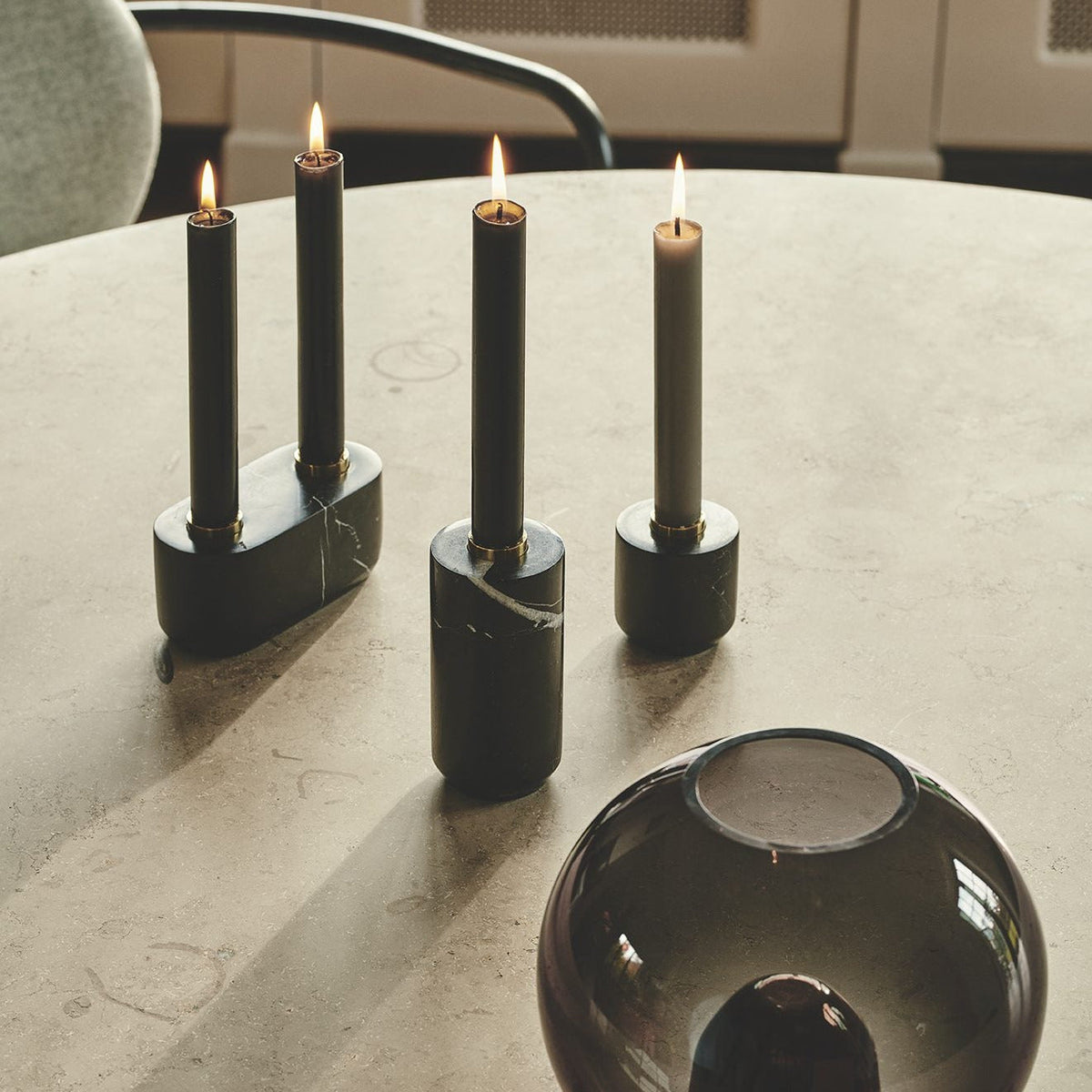 Sons of Marble Candle Holder - Smalls in black marble with lit candles on a stone table