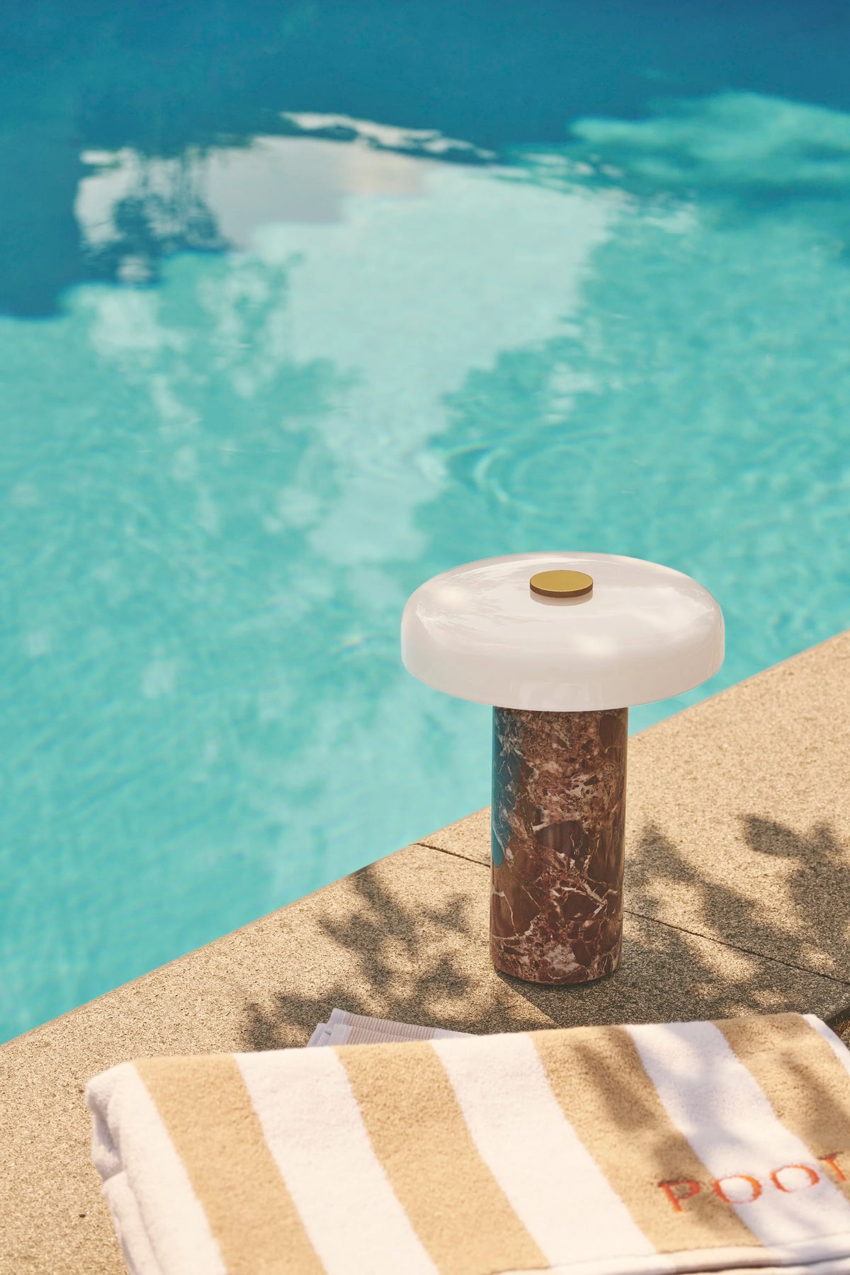Trip Table Lamp – Burgundy | Opal by a swimming pool on a sunlit stone edge