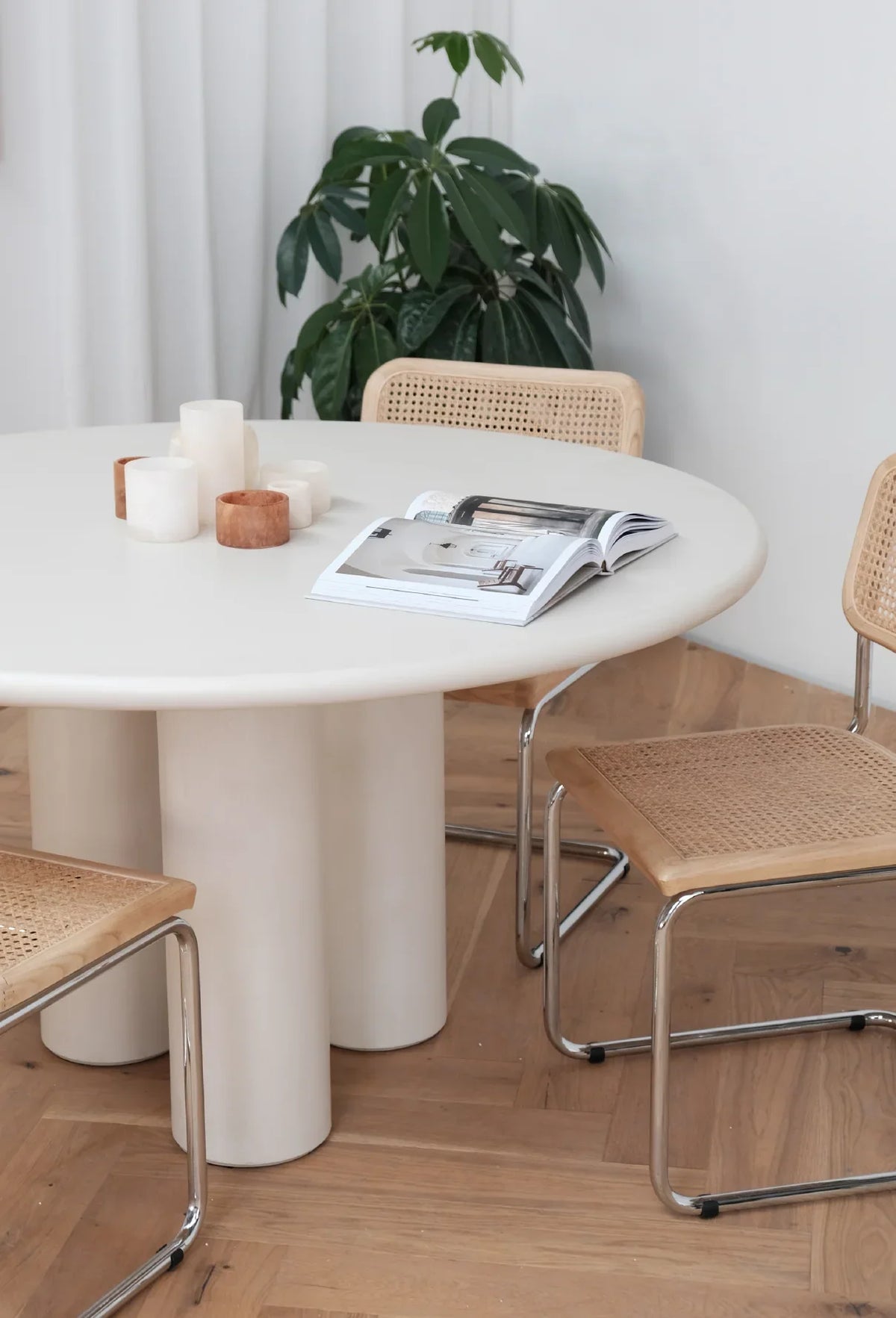 Elephant Dining Table with cane chairs in a bright dining room