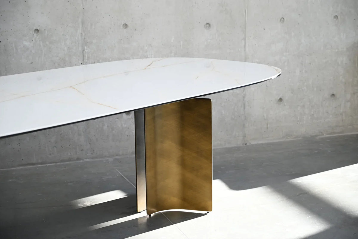 Sorrento Dining Table against a concrete wall in raking sunlight