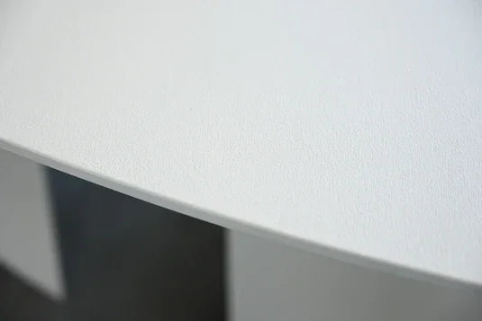 Tumuli Oval Dining Table detail of the matte white top over the sculpted base