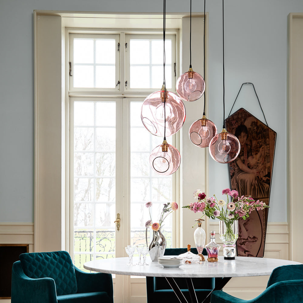 Ballroom XL Pink Pendant Lights clustered over a round marble dining table