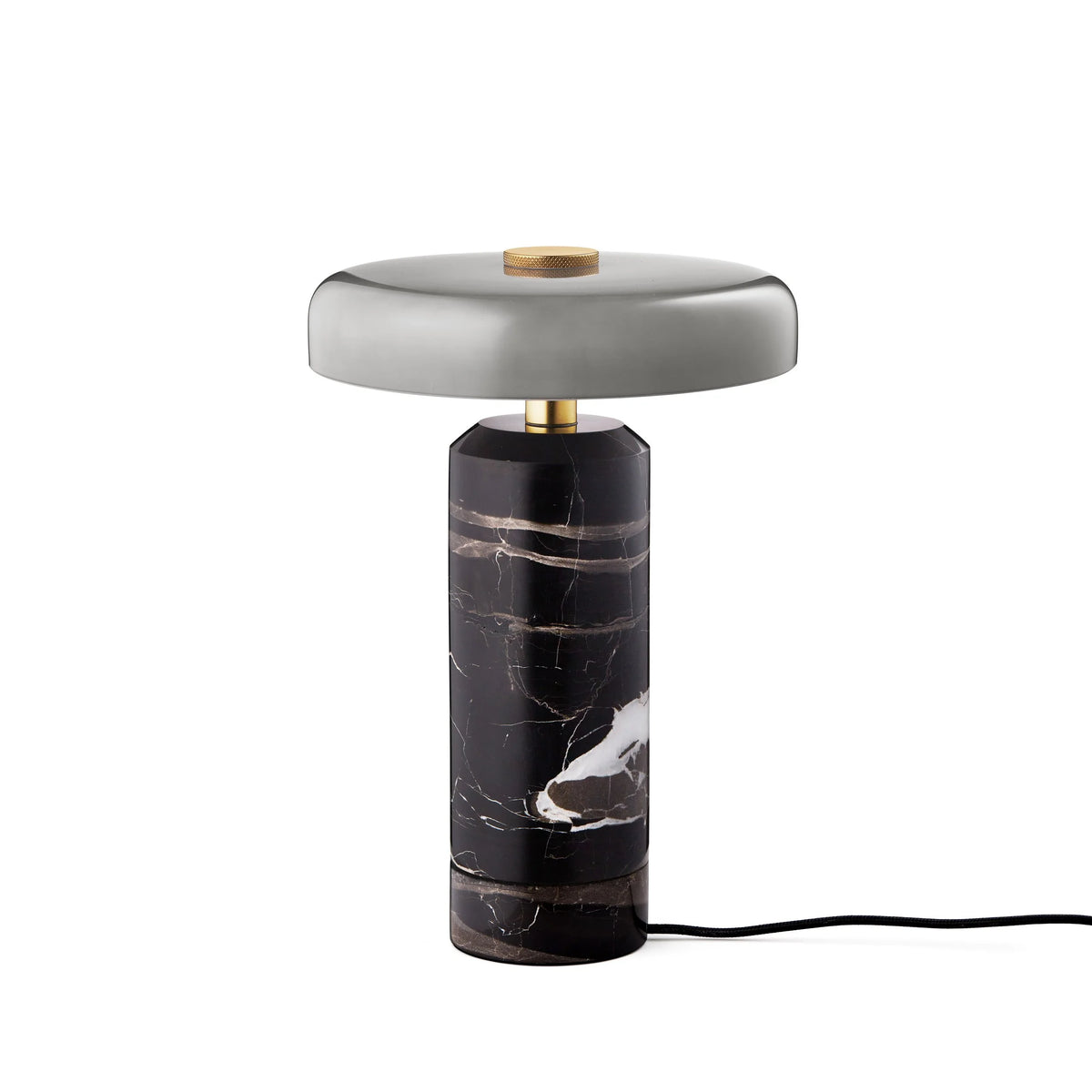 Trip Table Lamp in Ash / Grey on its charging base with cable