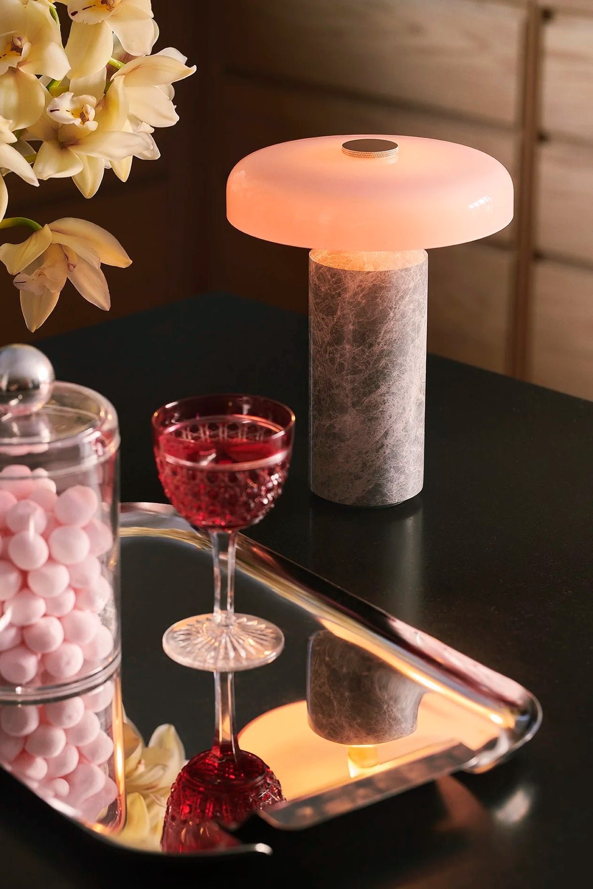 Trip Table Lamp – Silver | Rose lit on a dark table beside a mirrored cocktail tray