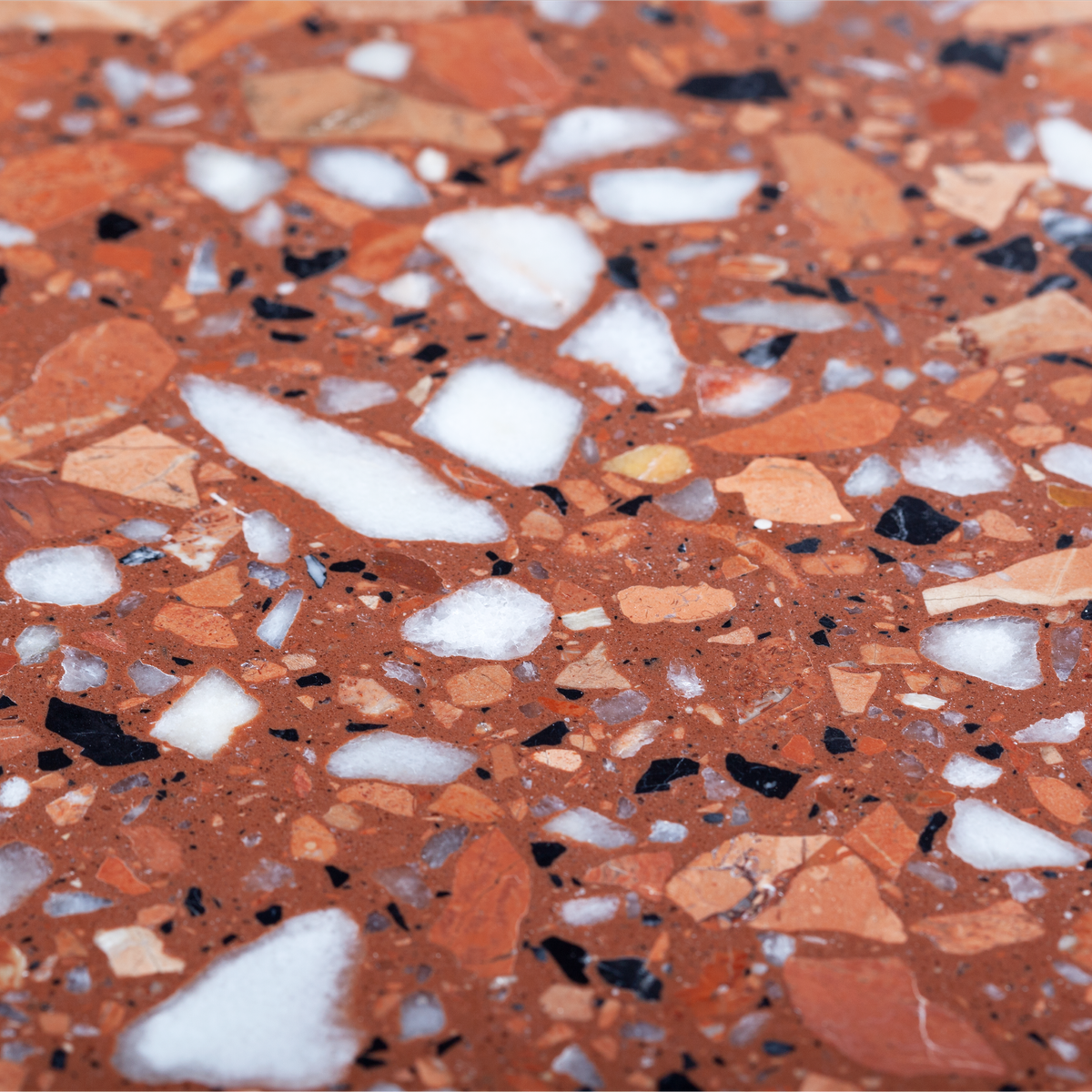 Riviera Dining Table macro of red terrazzo with white and black chips