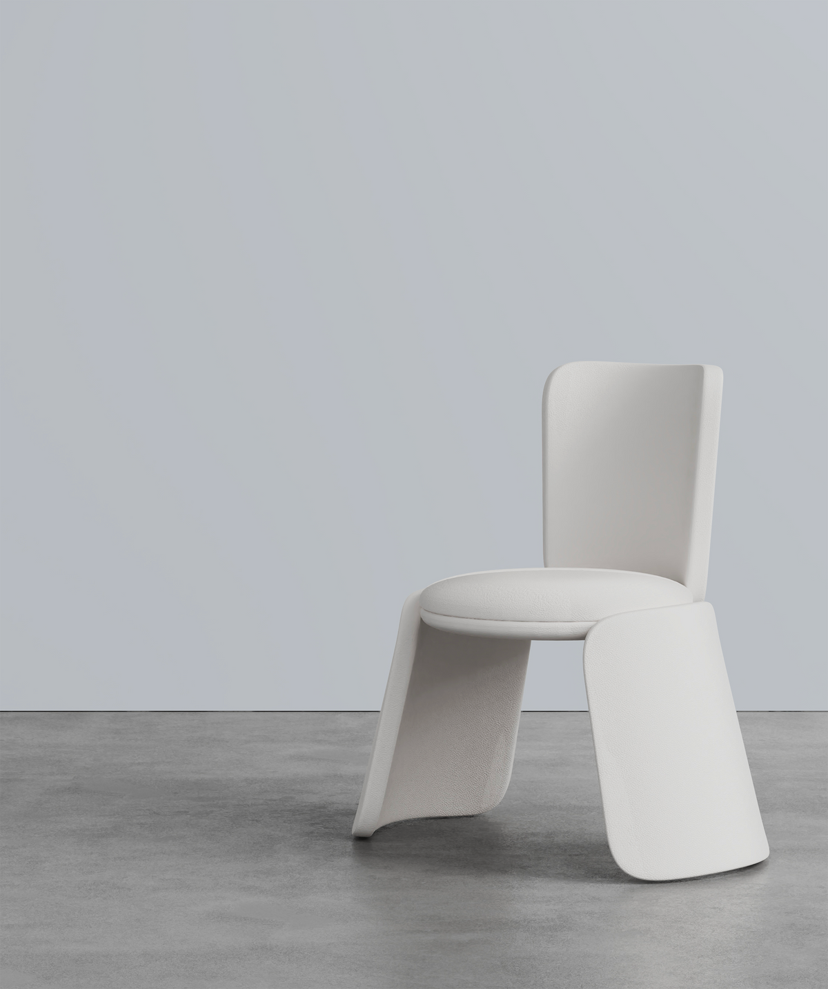 Inge Chair in off-white on a concrete floor, three-quarter view