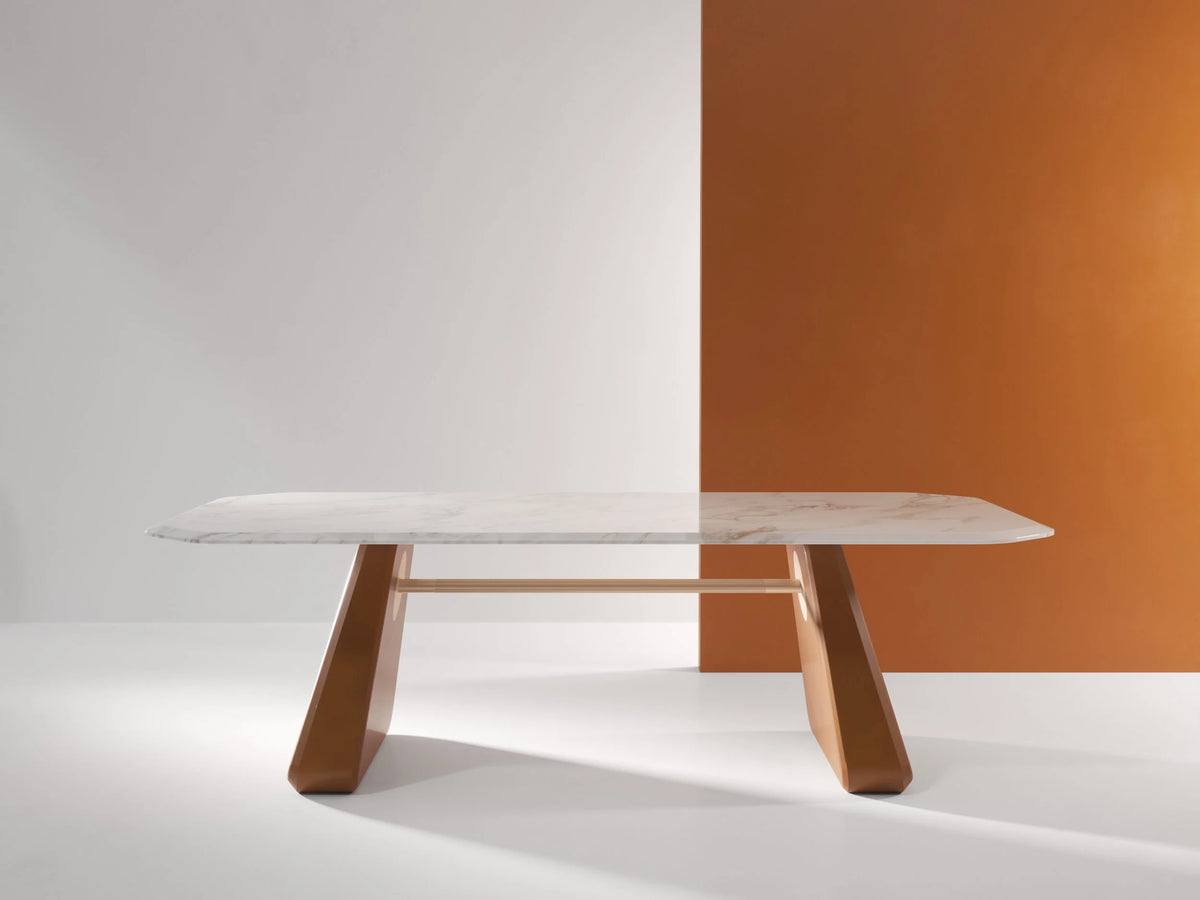 Inge Marble Dining Table with white marble top and cognac legs, front view in a studio