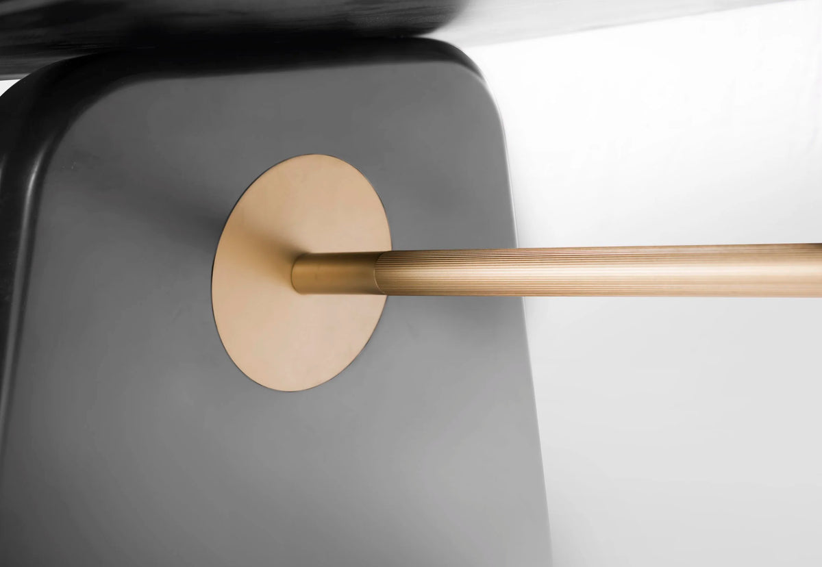 Inge Marble Dining Table close-up of the brass stretcher and disc detail on a dark leg