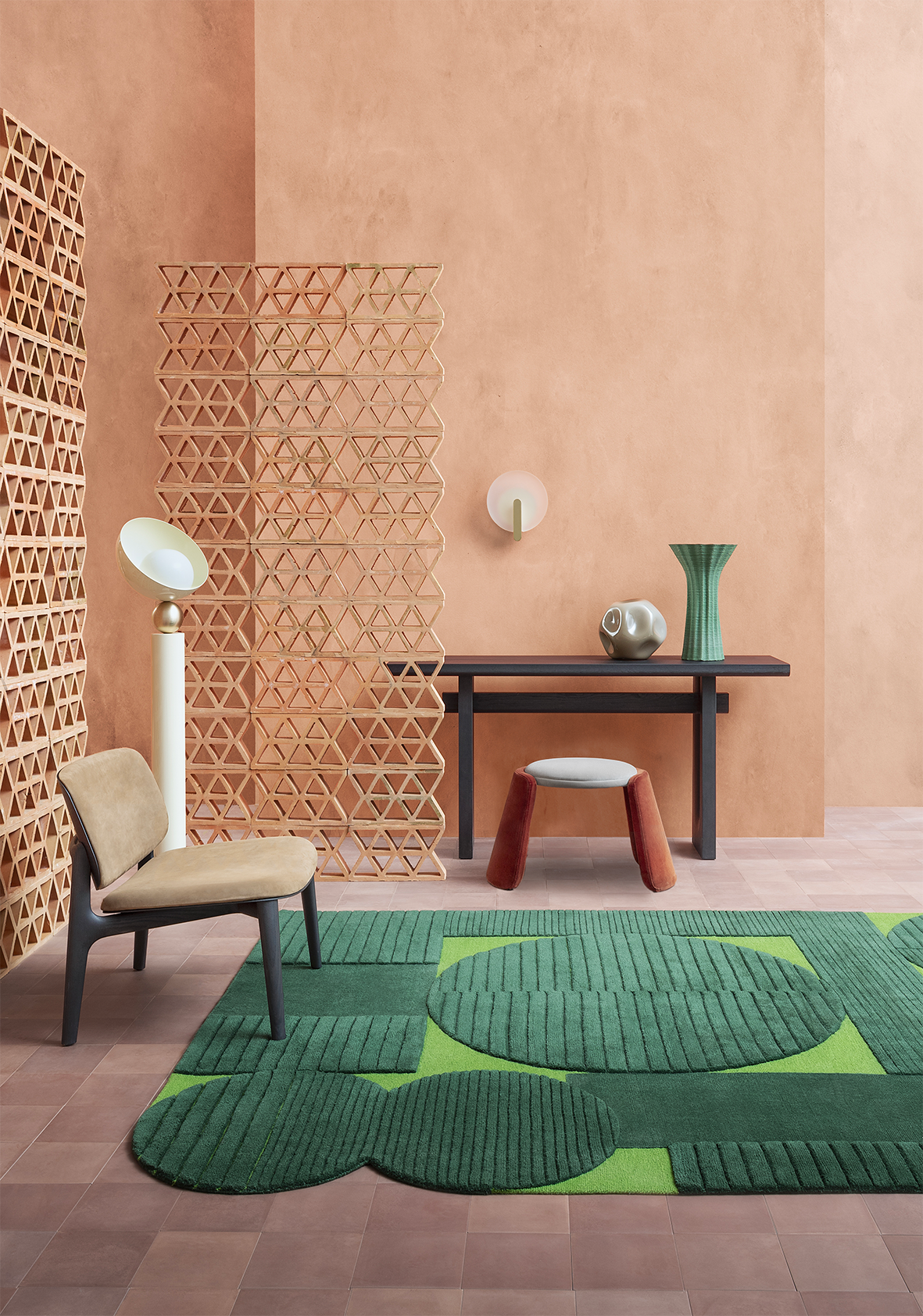 Inge Pouf in red in a terracotta room with a green rug