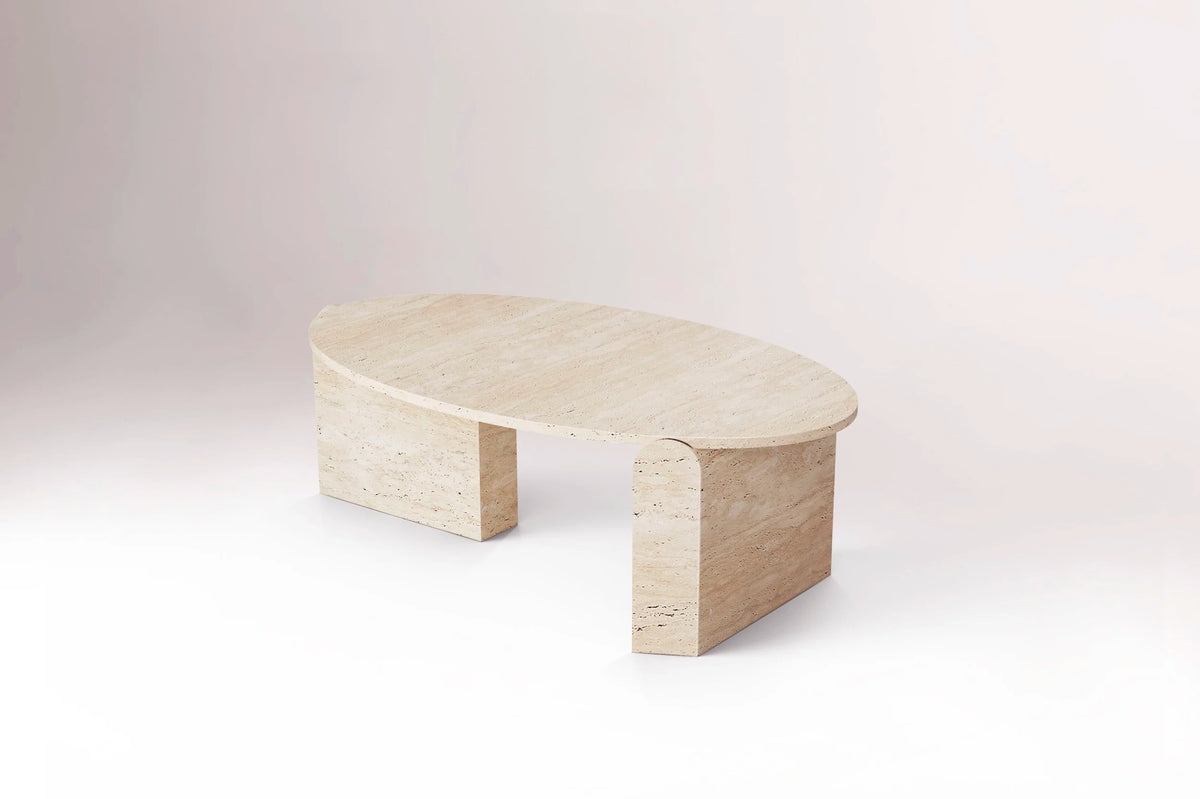 Jean Travertine Coffee Table, low side view on a pale backdrop