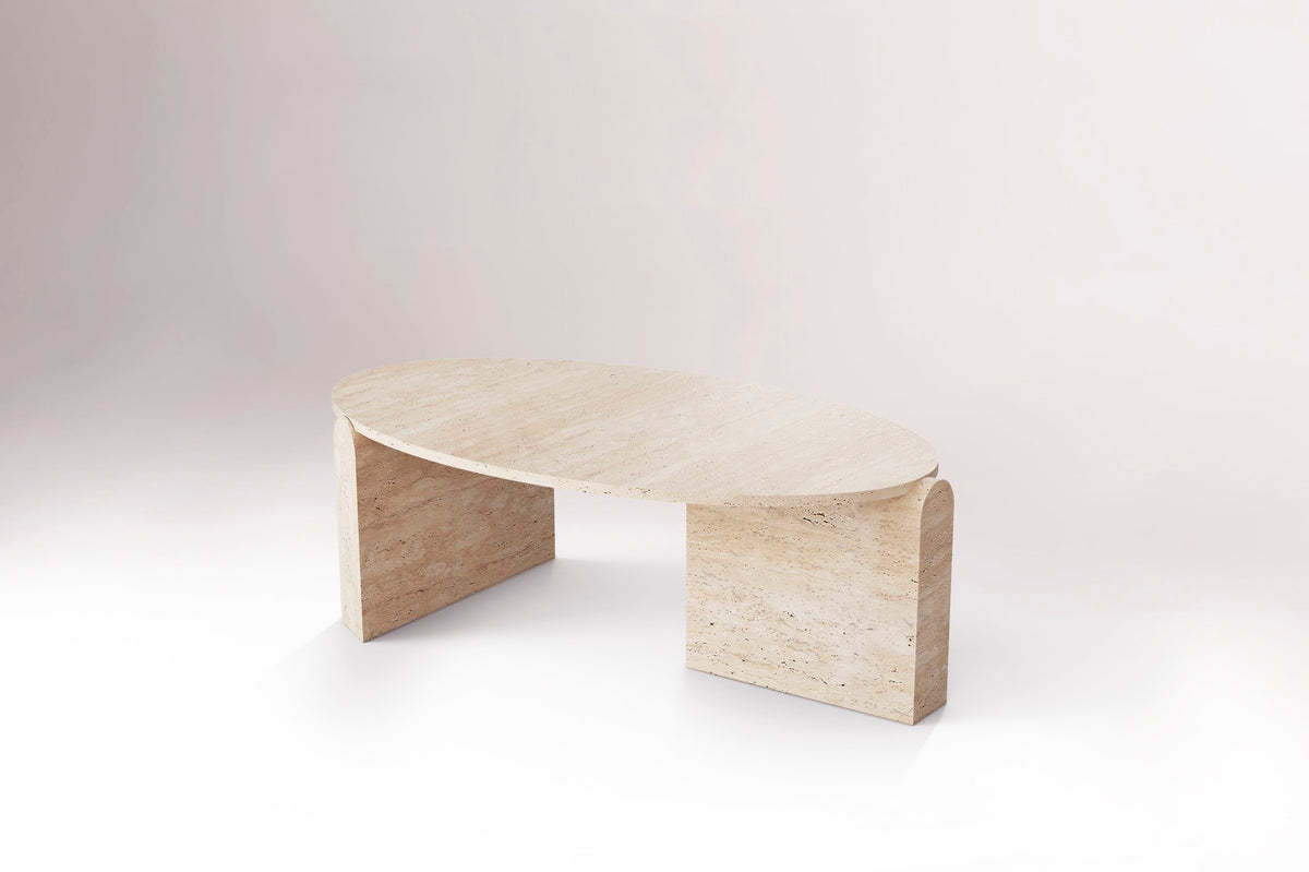Jean Coffee Table in Travertine, low side view on a pale backdrop