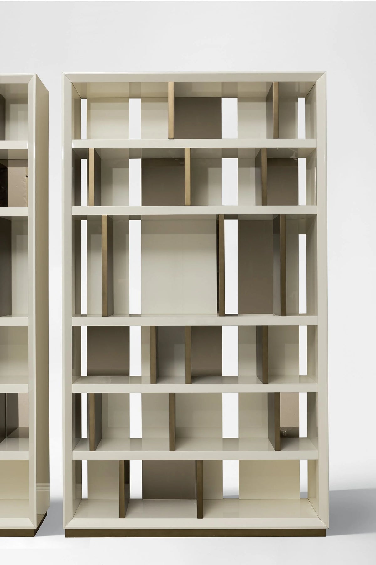 Magritte Bookcase in ivory lacquer with metallic accents, angled front view