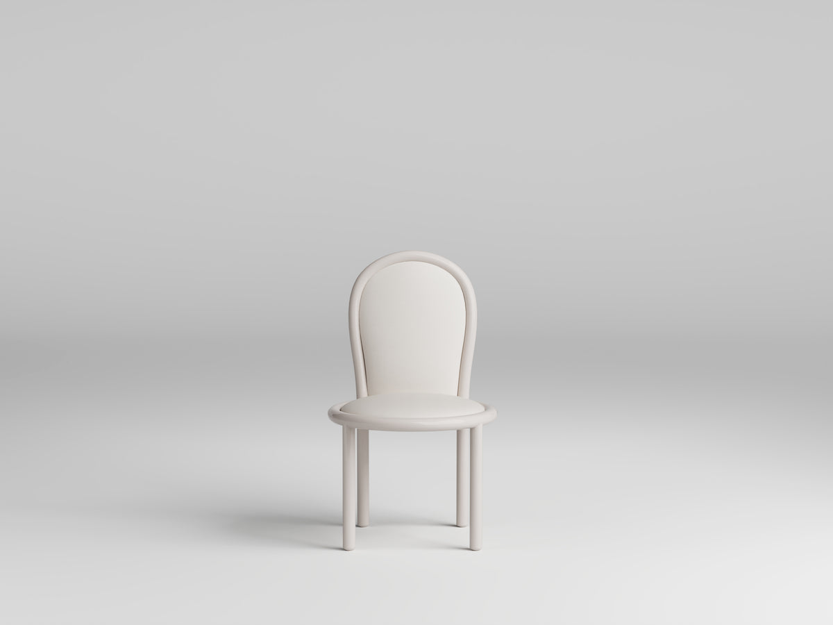 Masa Dining Chair in ivory on a grey backdrop, three-quarter view