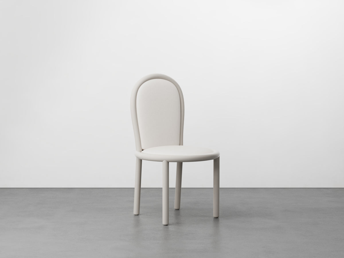 Masa Dining Chair with ivory frame and cream seat, front view on concrete