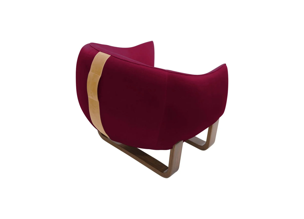 Milo Armchair back view in deep burgundy velvet with tan leather strap