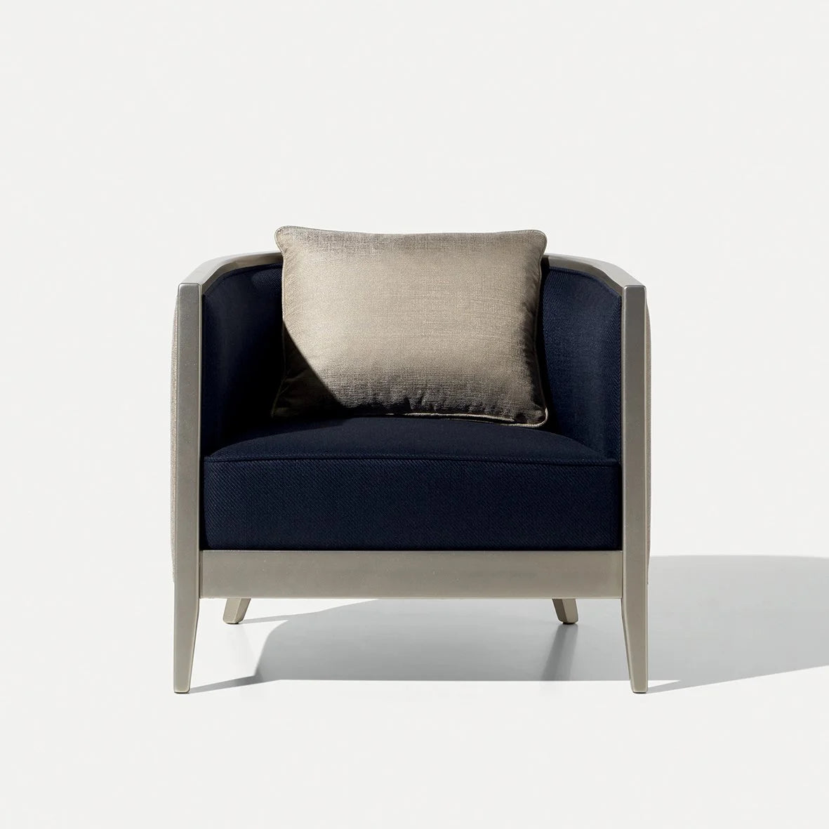Saten Armchair in navy with a taupe cushion and champagne frame, front view