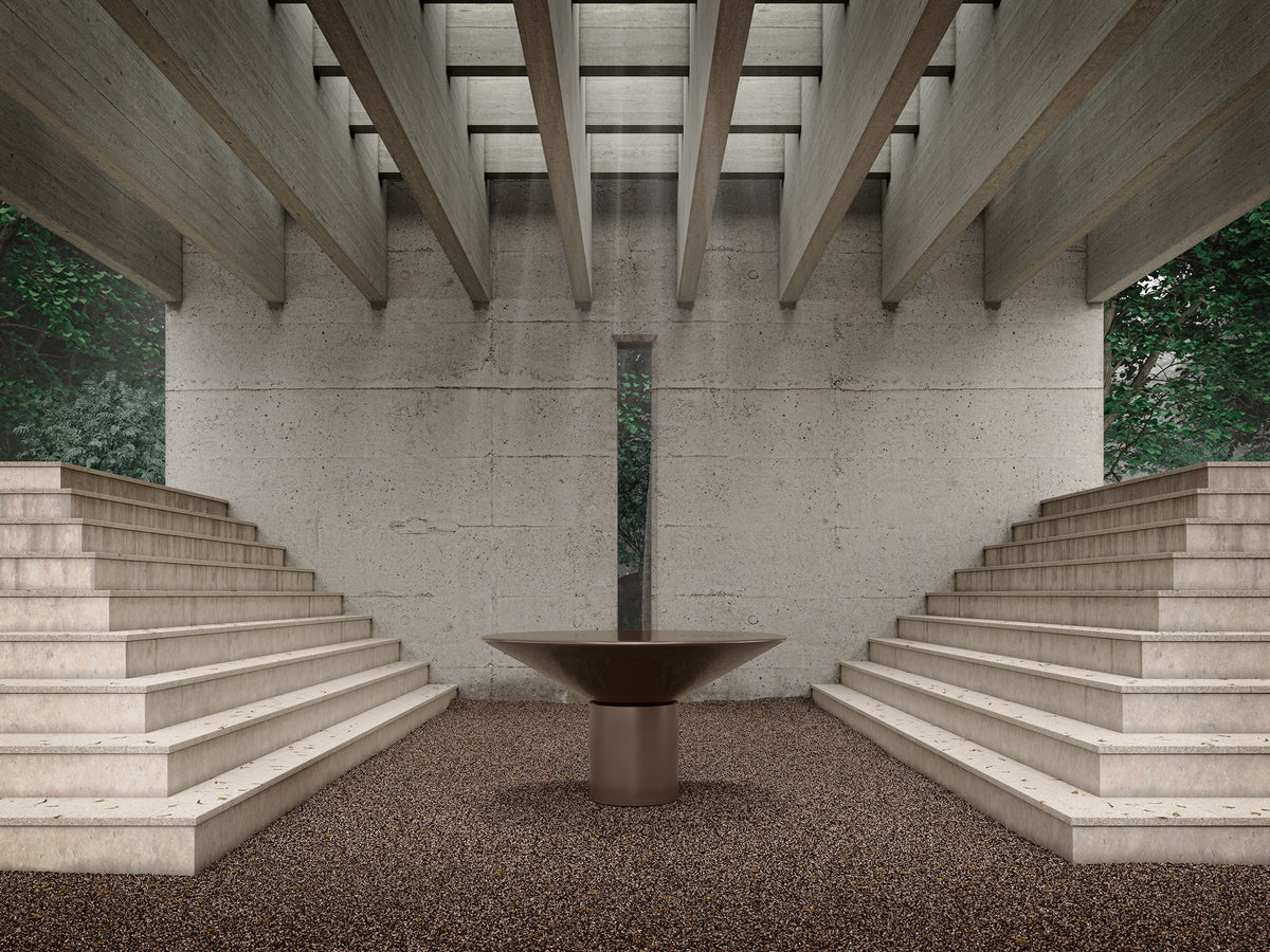 Silo Dining Table in taupe lacquer centred between concrete steps under a beamed roof