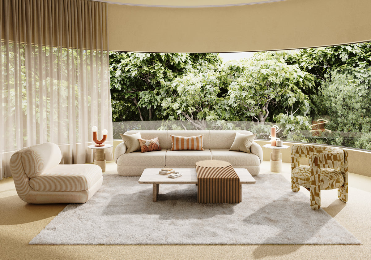 Choux Armchair in a garden-view living room with a cream sofa and shag rug