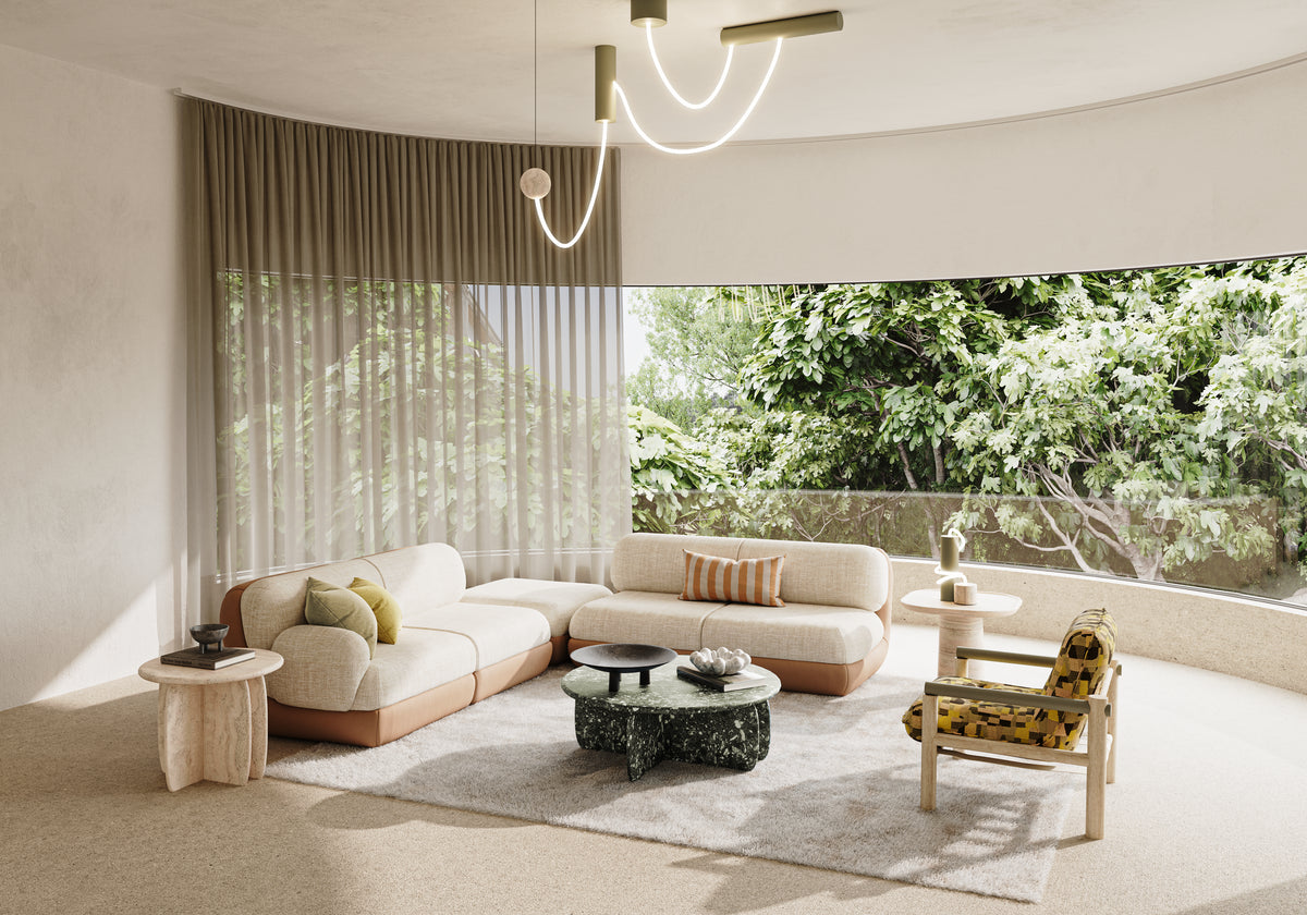James Armchair in a curved living room with a garden view and cream sofa