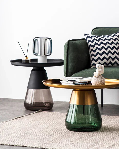 Duverre Side Table in brass with green glass in front of black with smoke glass