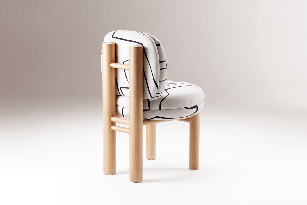 Aimi Chair in brushstroke fabric, rear three-quarter view on white