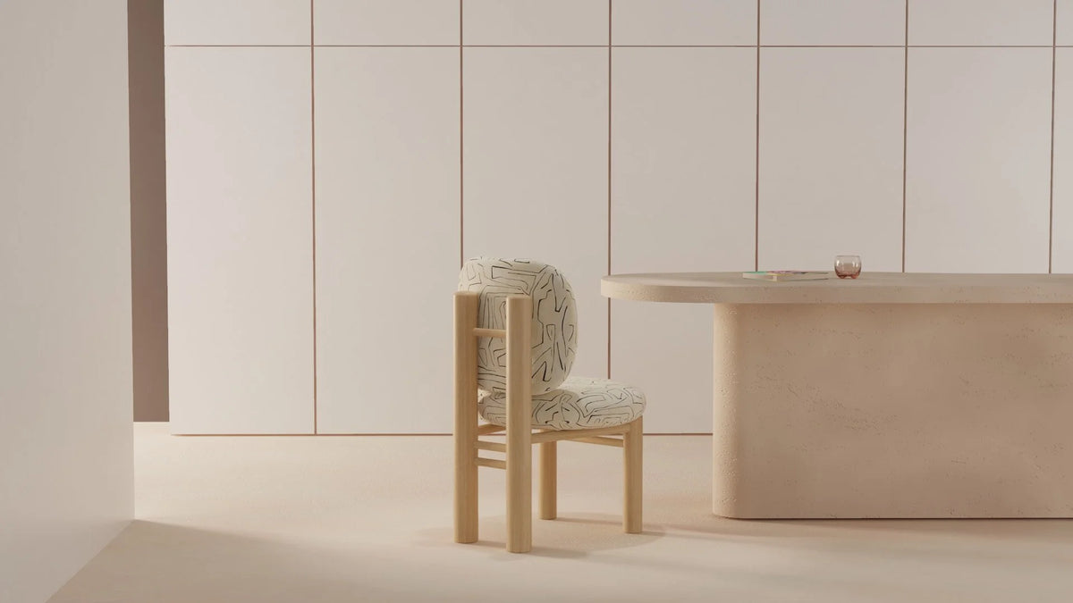 Aimi Chair beside a cream dining table in a minimal beige room