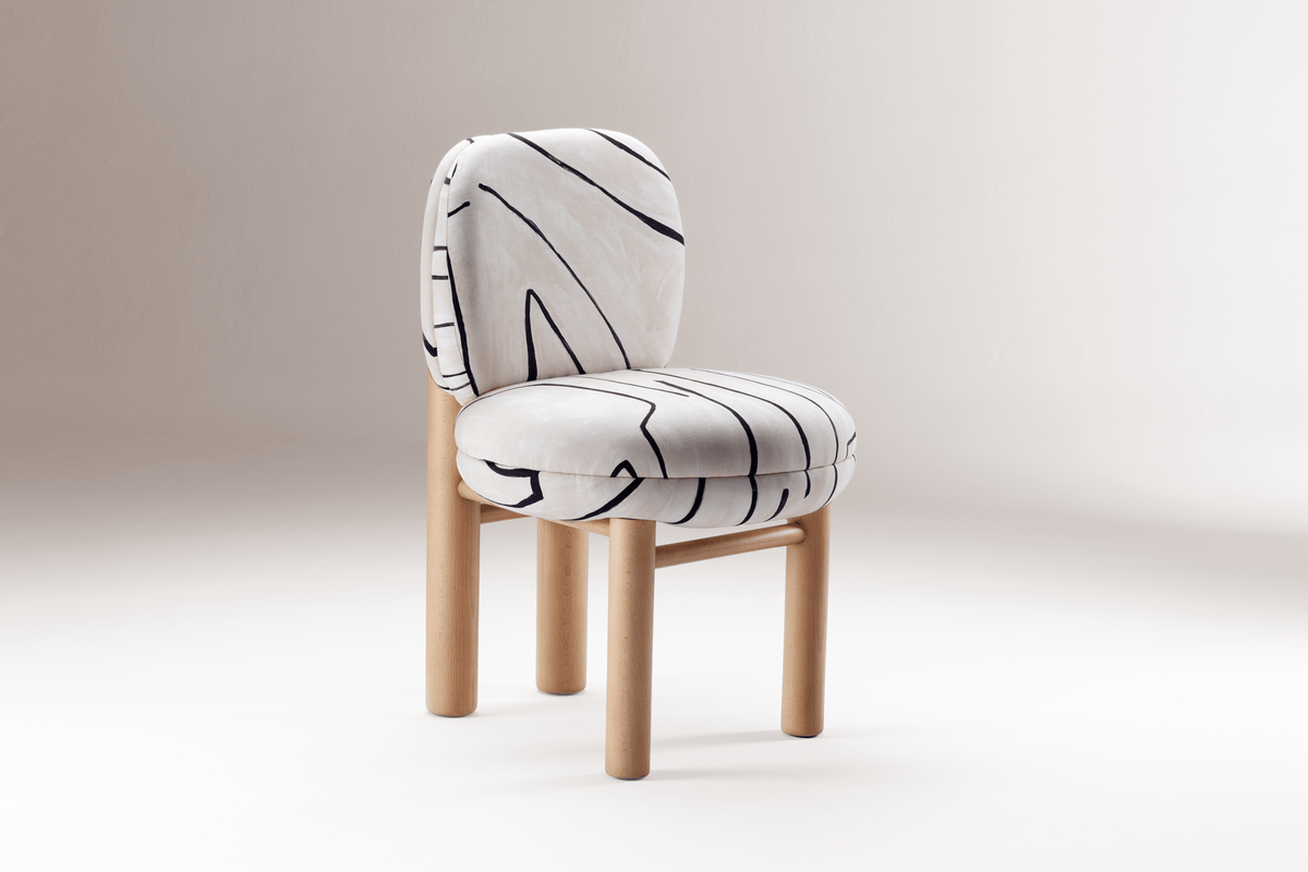 Aimi Chair in brushstroke fabric with beech legs, three-quarter view on white