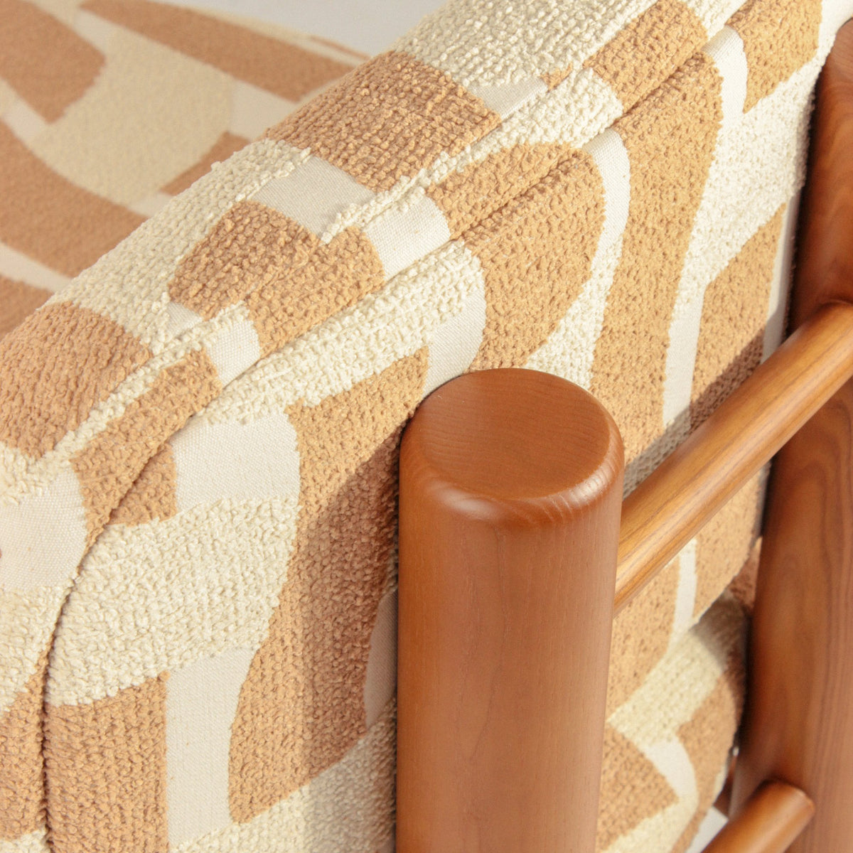 Aimi Lounge Chair, close-up of the cream and terracotta fabric against the wood frame