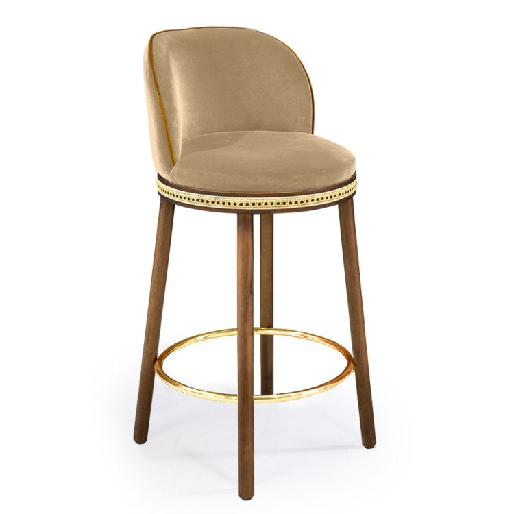 Alma Counter Stool in Dune velvet with natural walnut legs and polished brass footrest