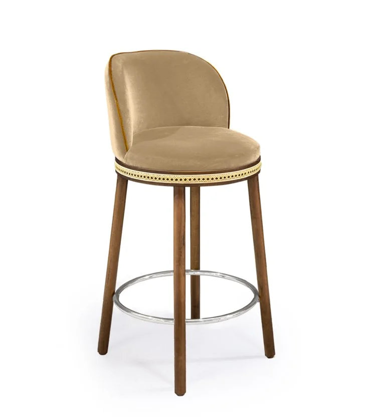 Alma Counter Stool in Dune velvet with natural walnut legs and polished nickel footrest