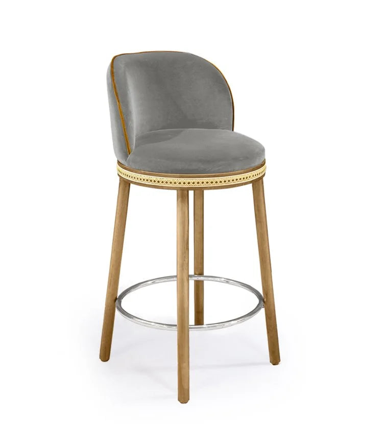 Alma Counter Stool in Fog velvet with natural oak legs and polished nickel footrest