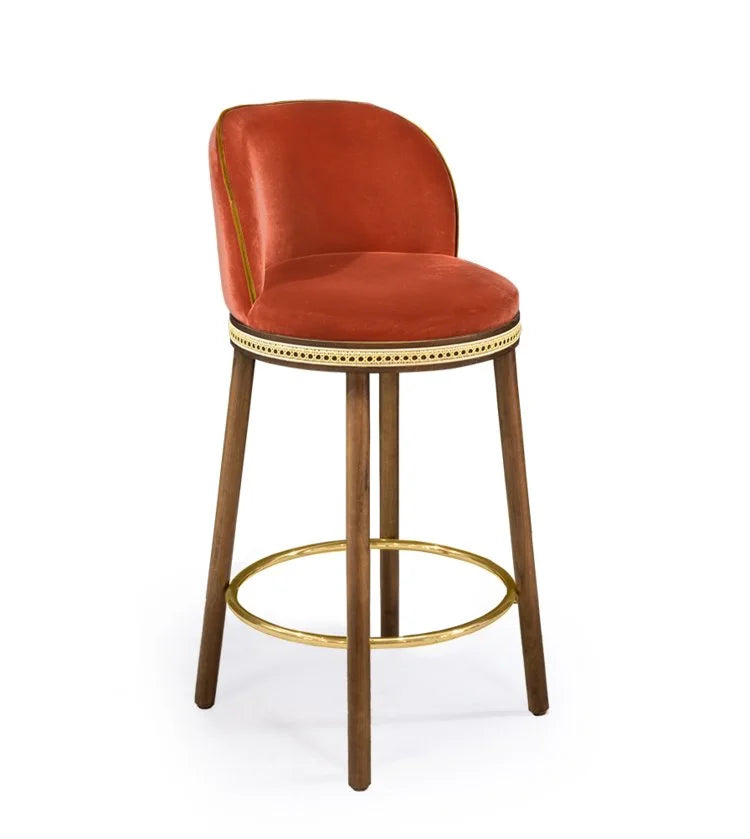 Alma Counter Stool in Papaye velvet with natural walnut legs and satin brass footrest