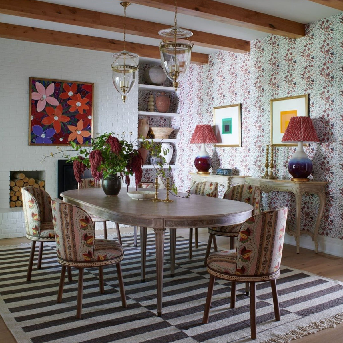 Alma Dining Chair in floral fabric around a dining table on a striped rug