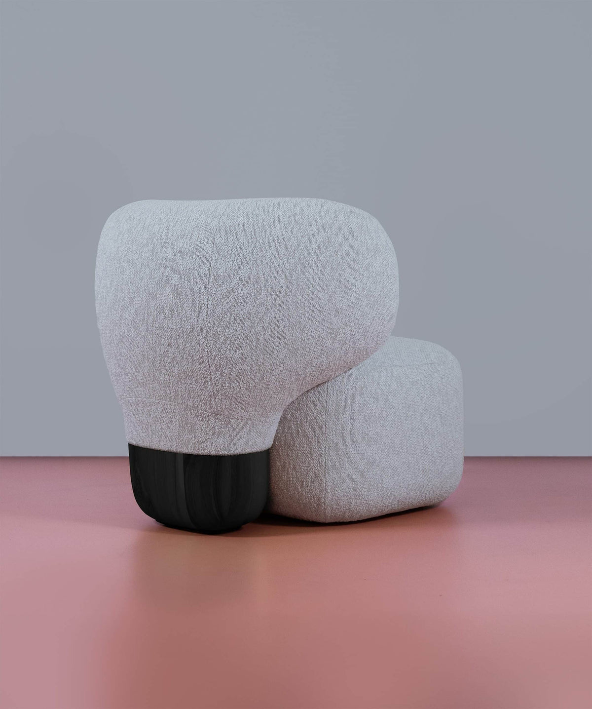 Asawa Lounge Chair in textured white bouclé with black base on a pink floor