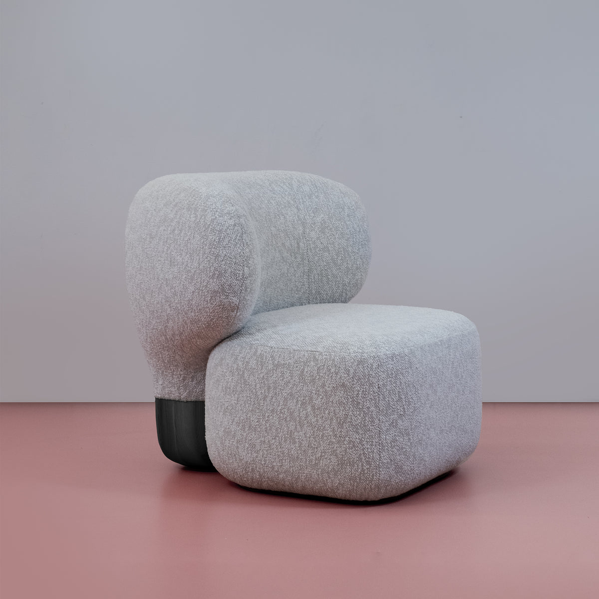 Asawa Lounge Chair in grey bouclé, right-facing three-quarter view on a pink floor