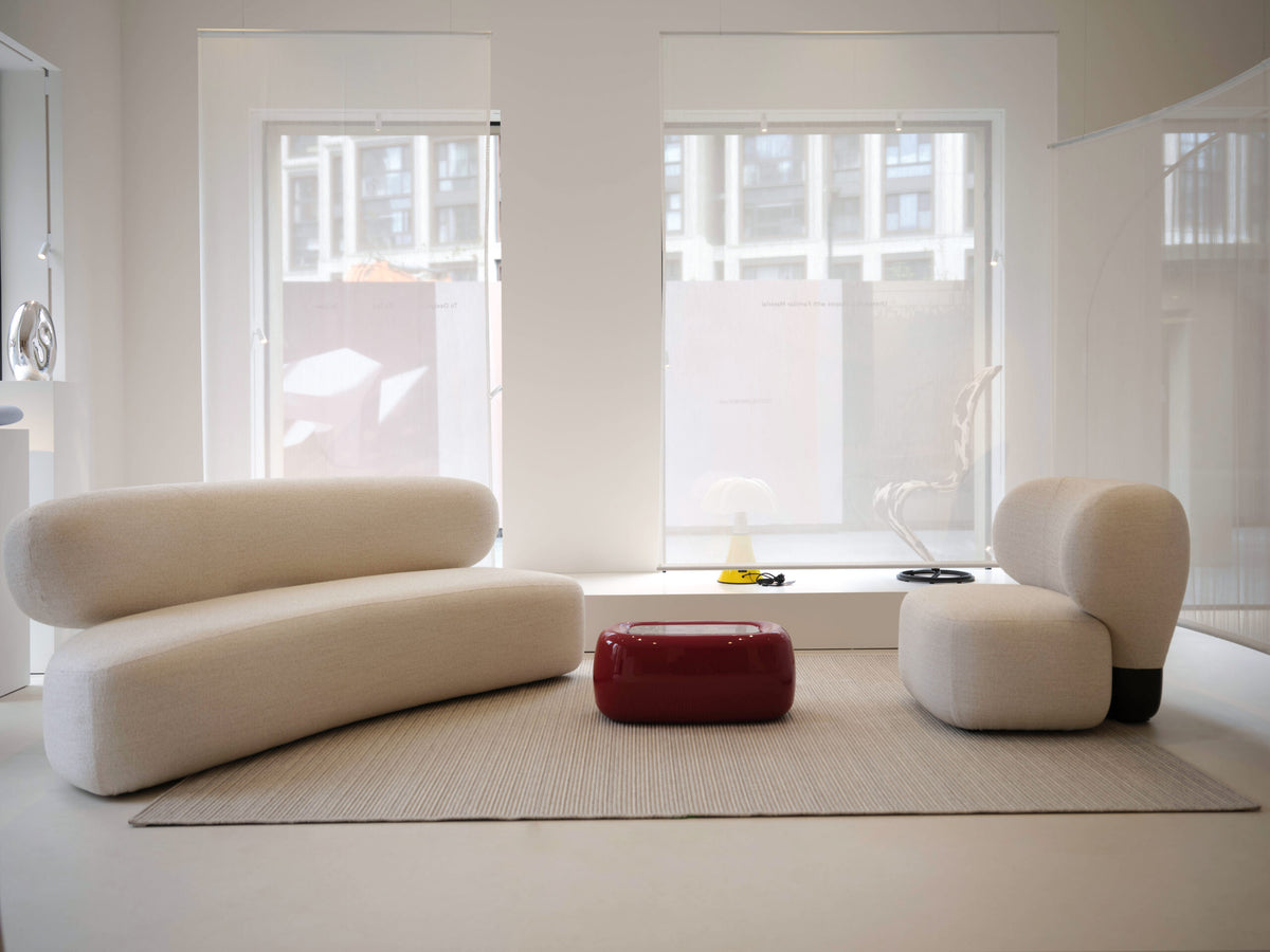 Asawa Sofa with a lounge chair and red table in a bright white room