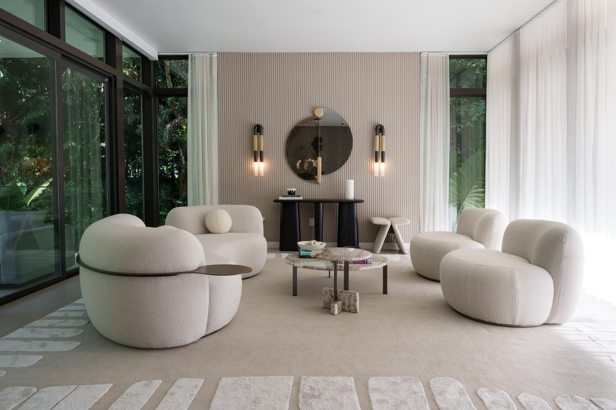 B-15 Z Lounge Chairs in white bouclé grouped in a glass-walled lounge with garden views