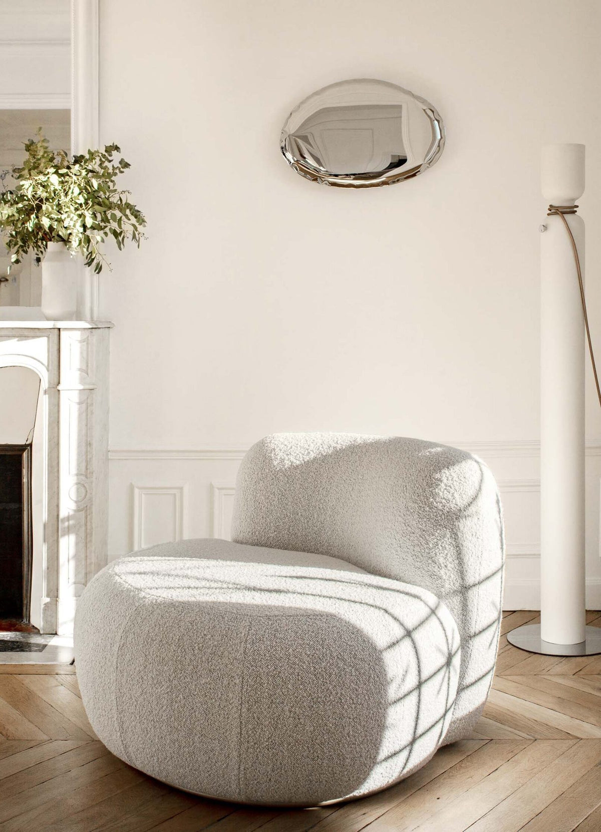 B-15 Z Lounge Chair in ivory bouclé with window shadows on a herringbone floor