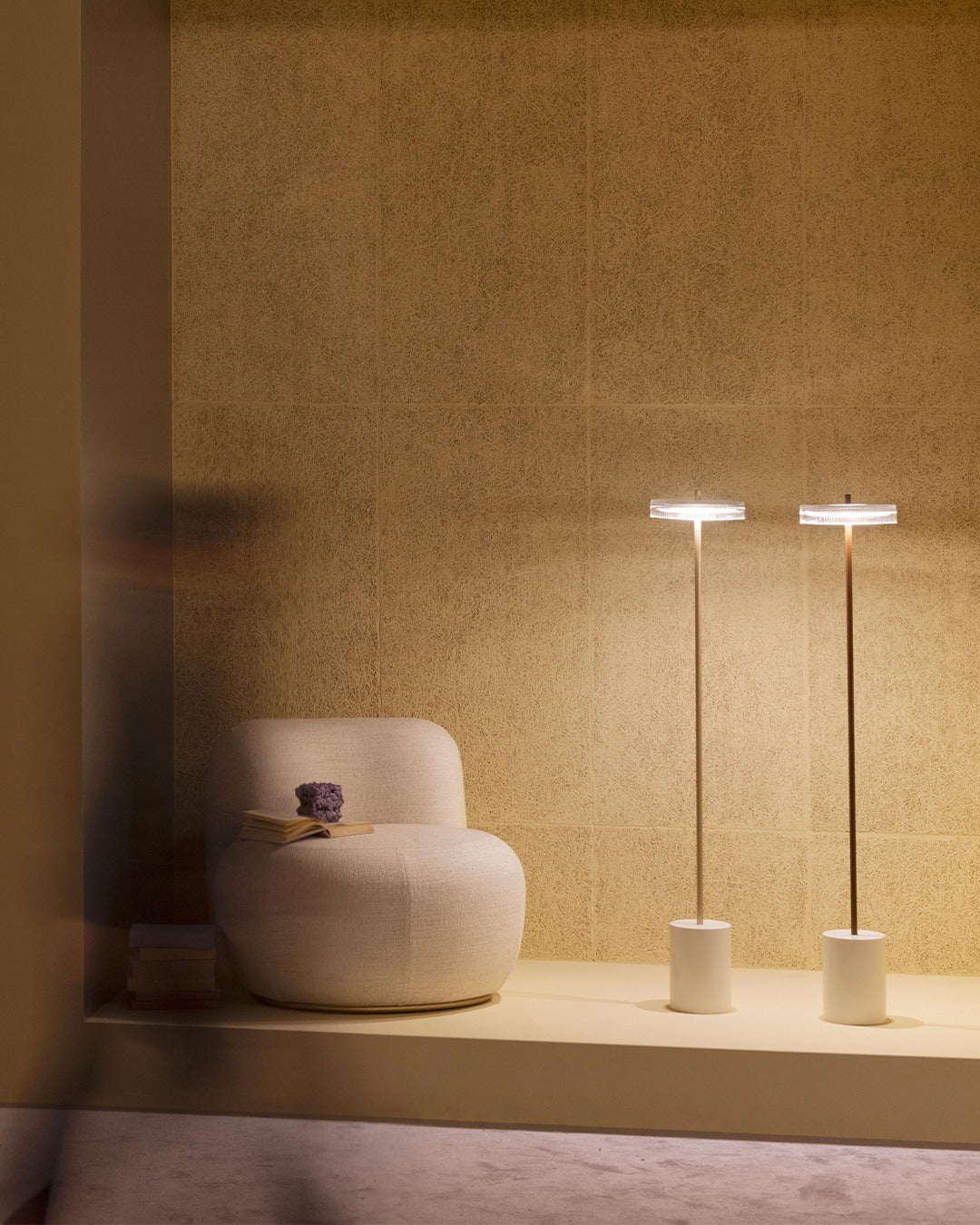 B-15 Z Lounge Chair in blush bouclé in a golden alcove with two slim floor lamps