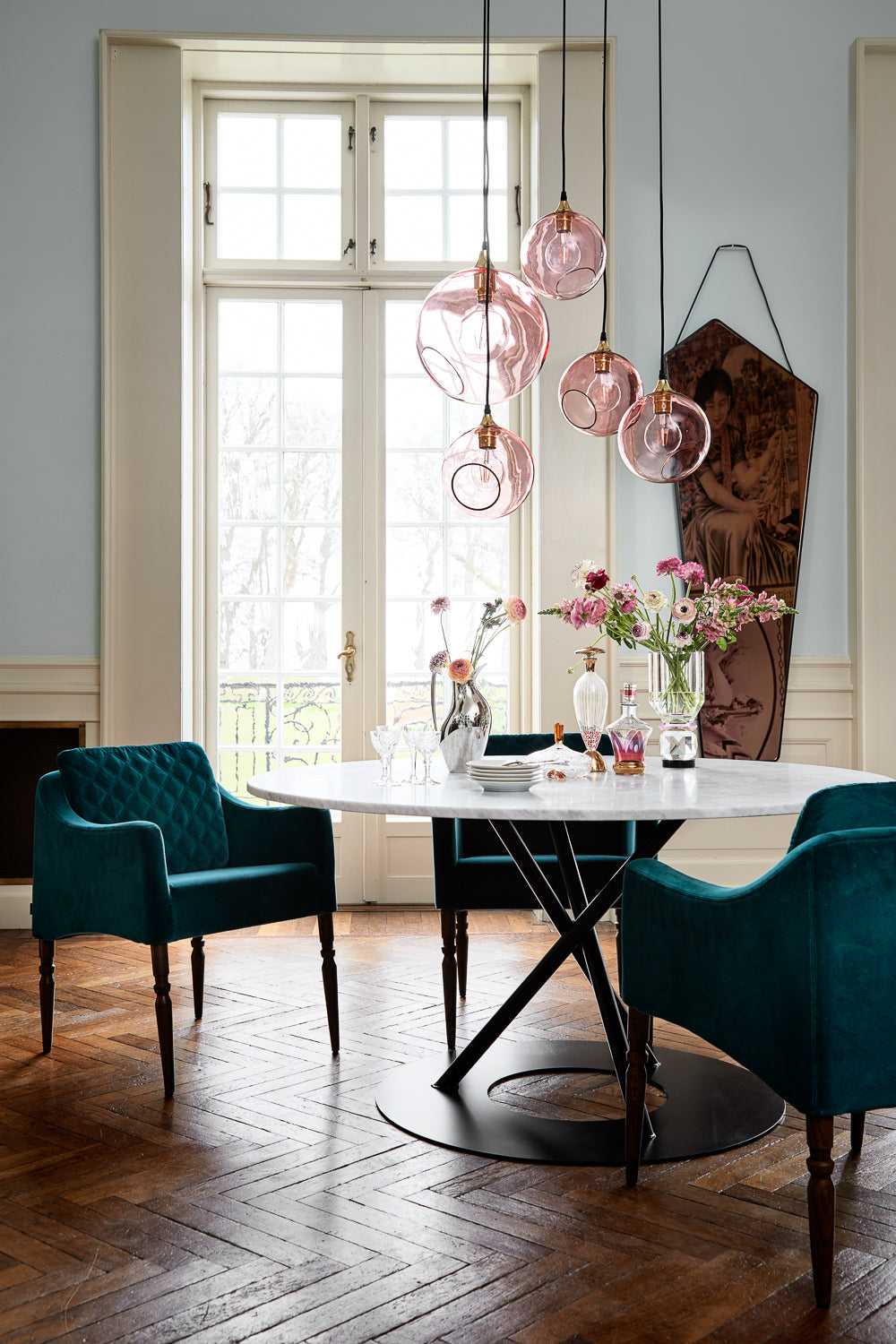 Pink Ballroom Pendant Lights over a round dining table by Maison Burgos