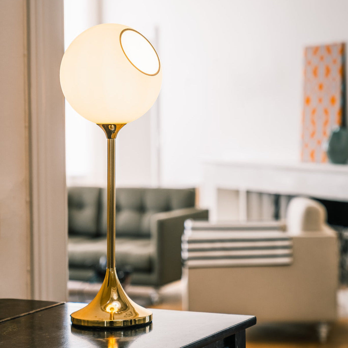 Ballroom Table Lamp tall version in White Snow glass with gold base in a living room