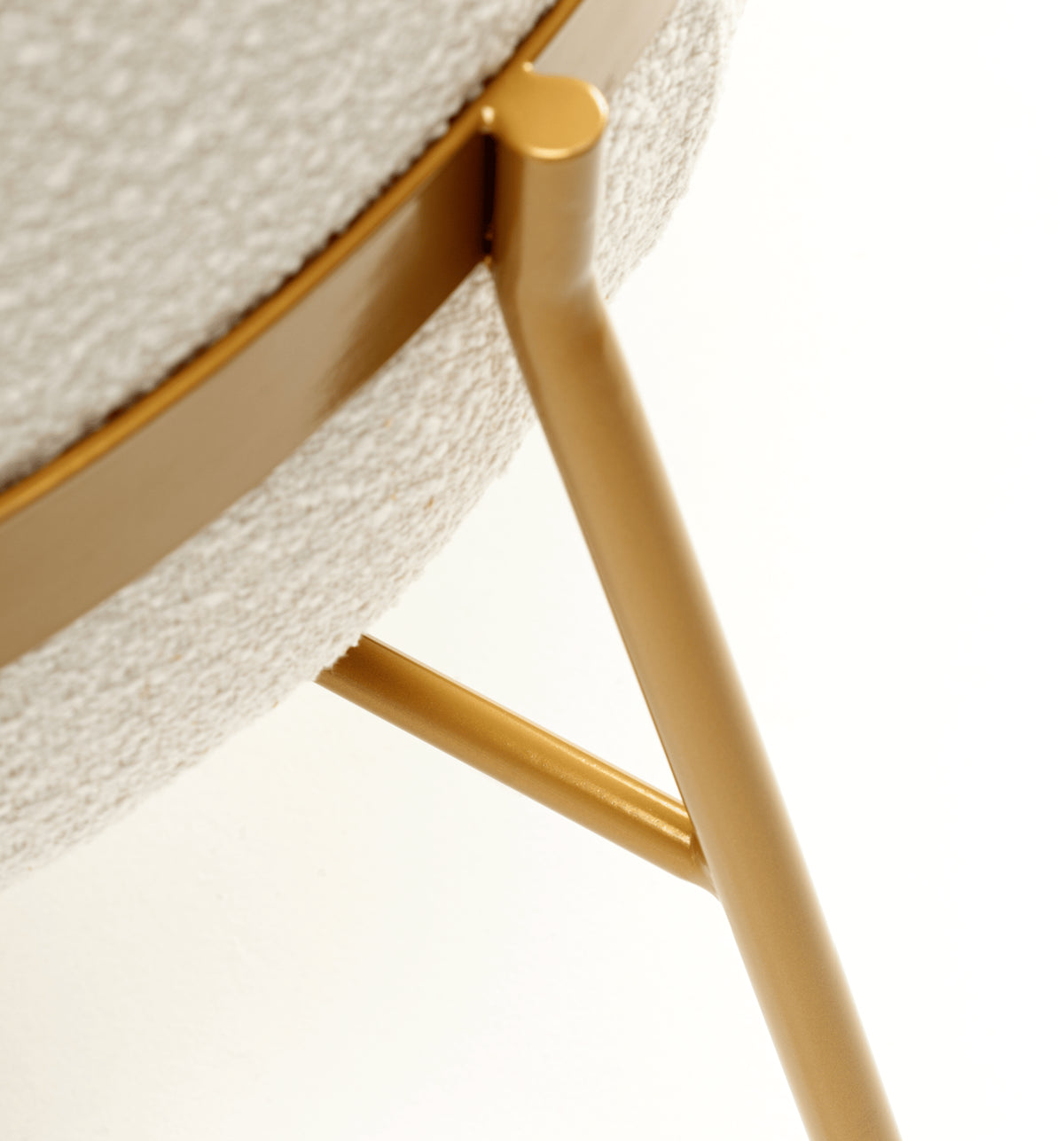 Blop Armchair close-up of gold leg joint against cream bouclé