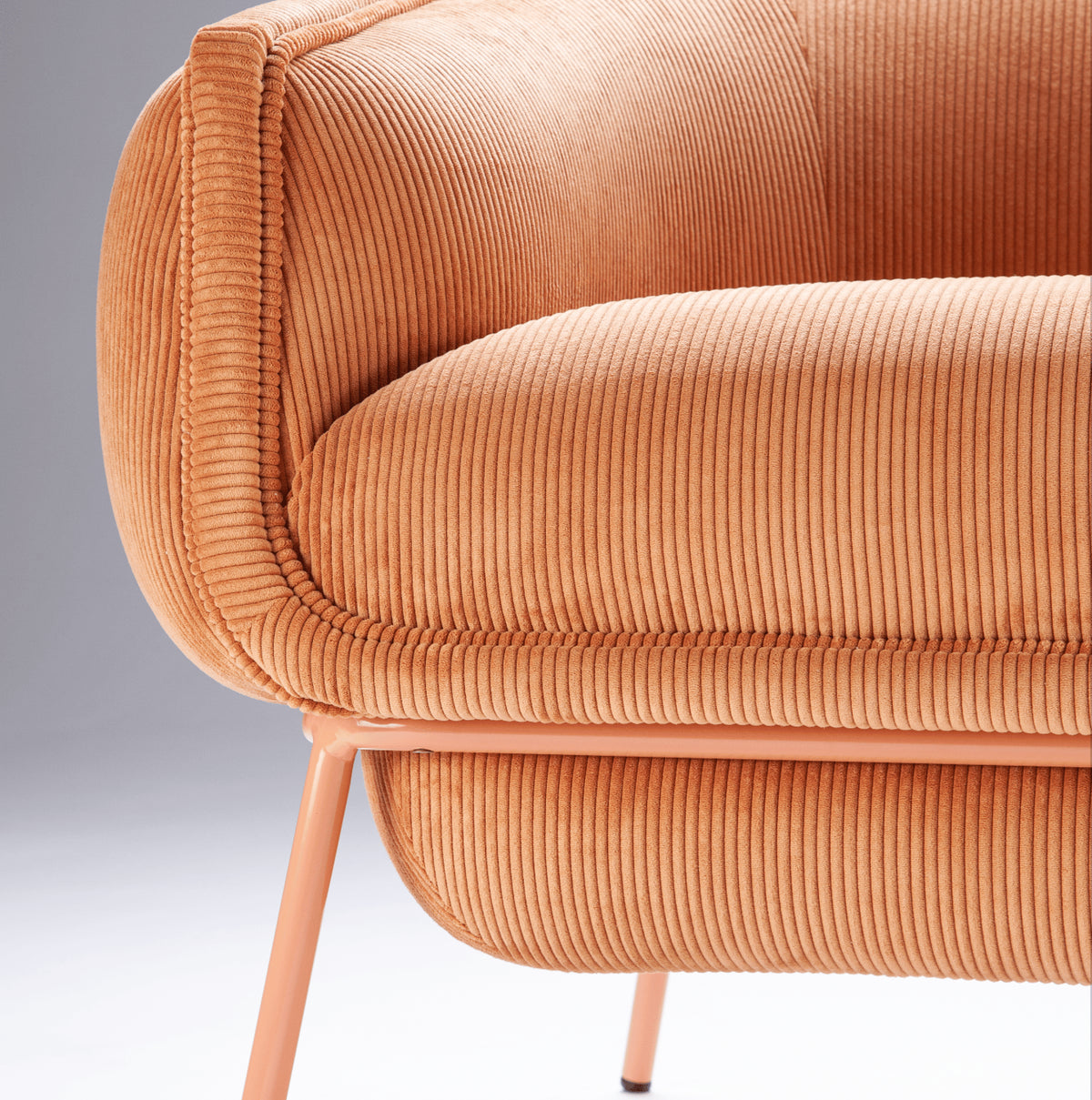 Blop Armchair in terracotta corduroy, close-up of seat and leg