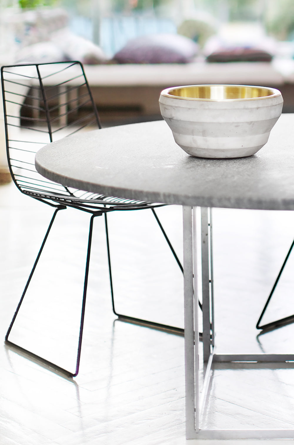 Bowl Job concrete and brass bowl styled on a dining table, close view, by Maison Burgos