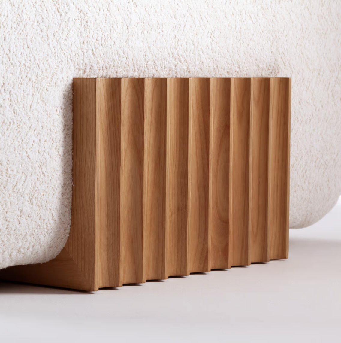 Carmel Chaise Lounge, close-up of the fluted Natural Oak base under cream boucle