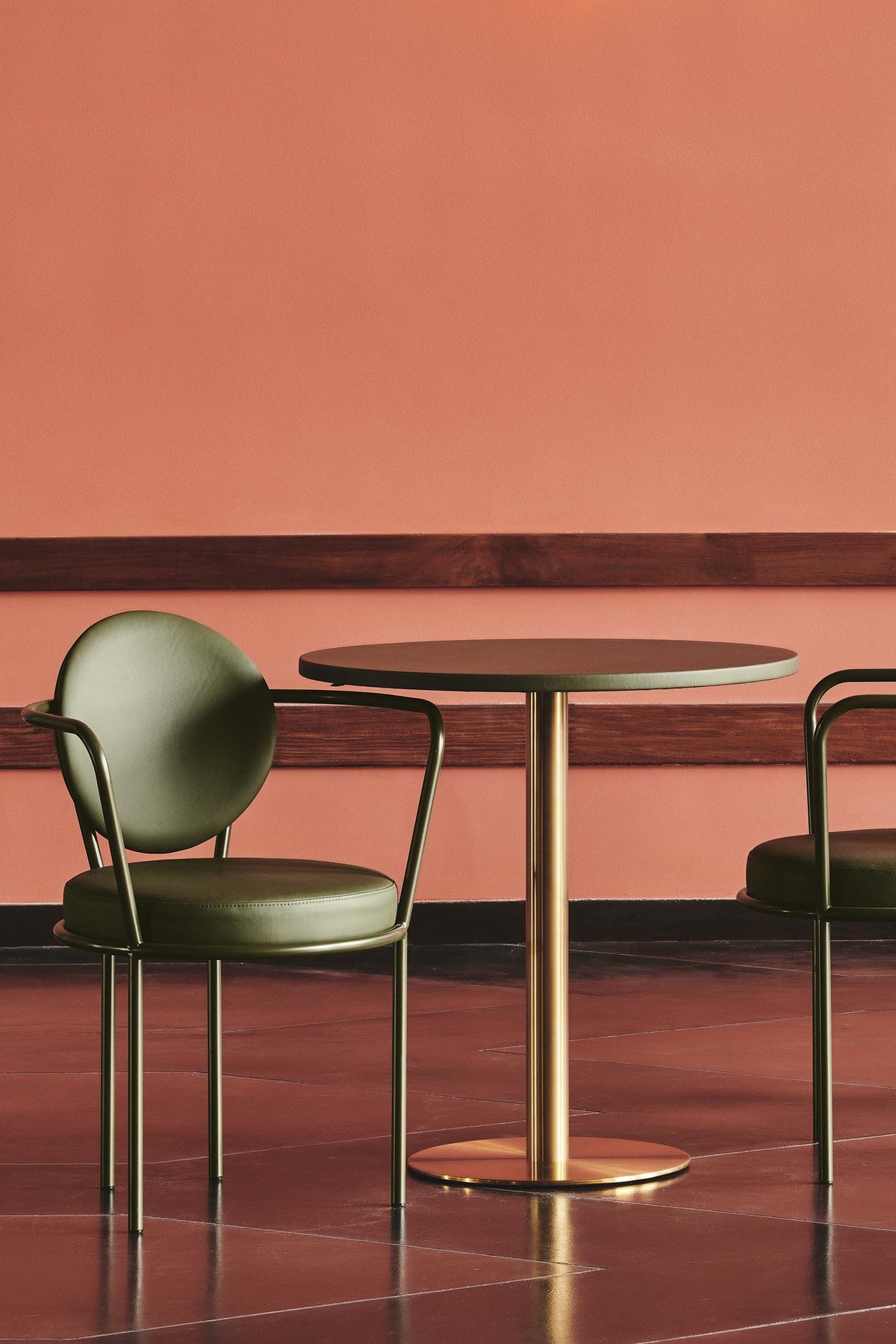 Casablanca Chair in moss with black frame at a cafe table by Maison Burgos