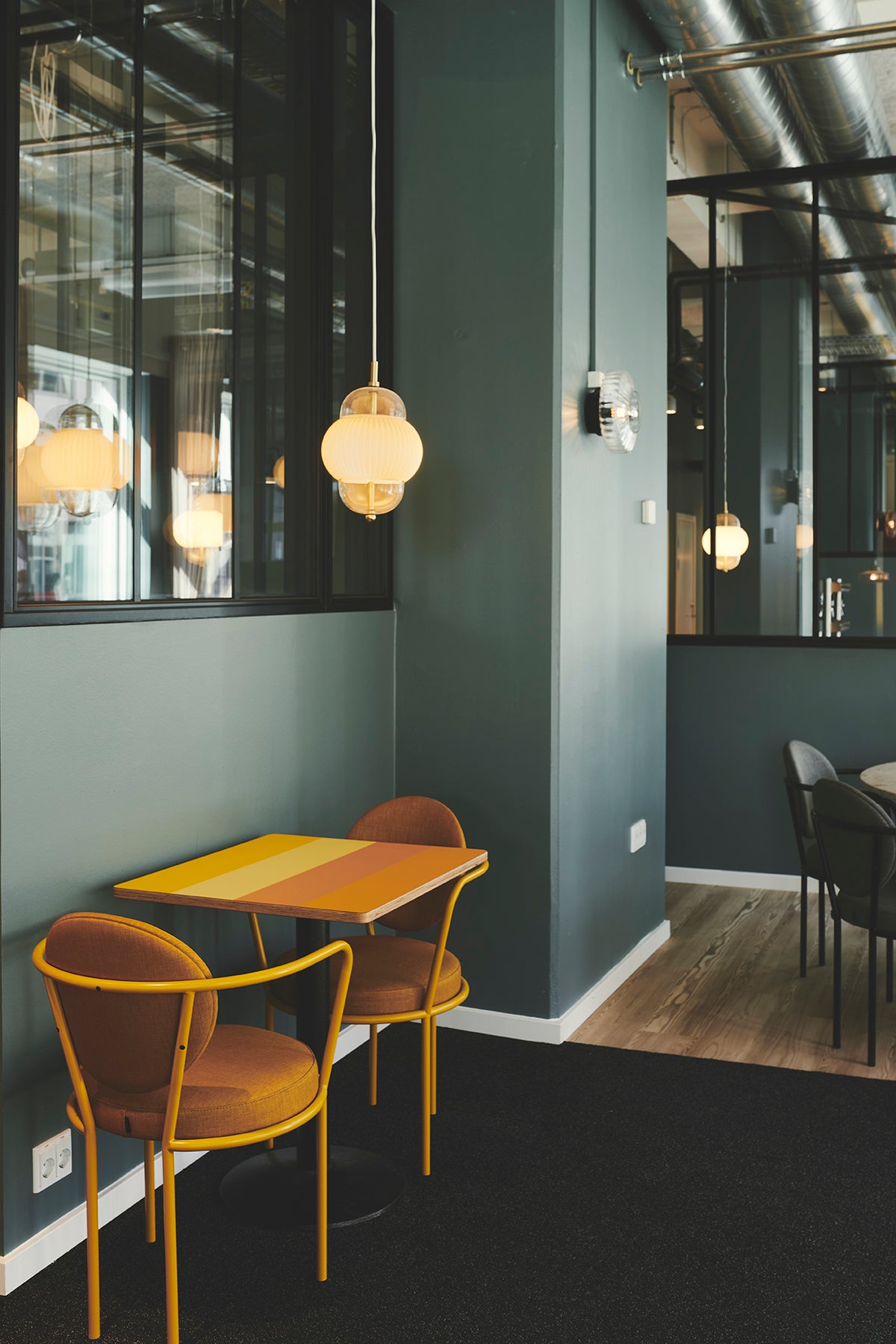 Casablanca Chair with orange frame at a bistro table by Maison Burgos
