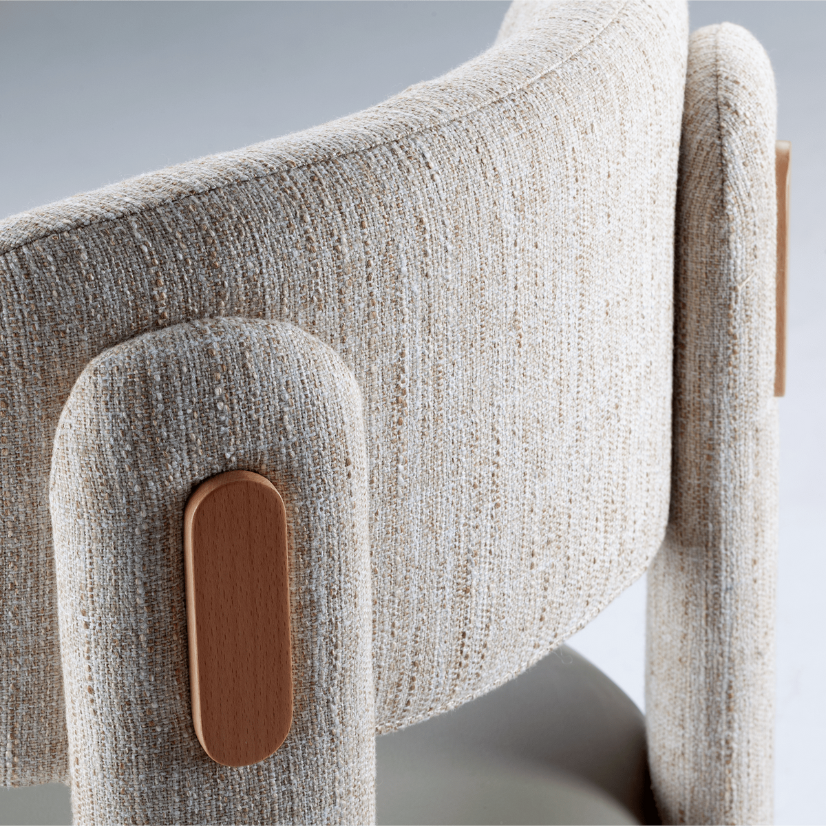 Choux Dining Chair close-up of ivory weave backrest and wood leg inlay